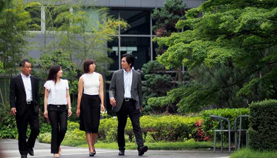 a group of business professional walking outside