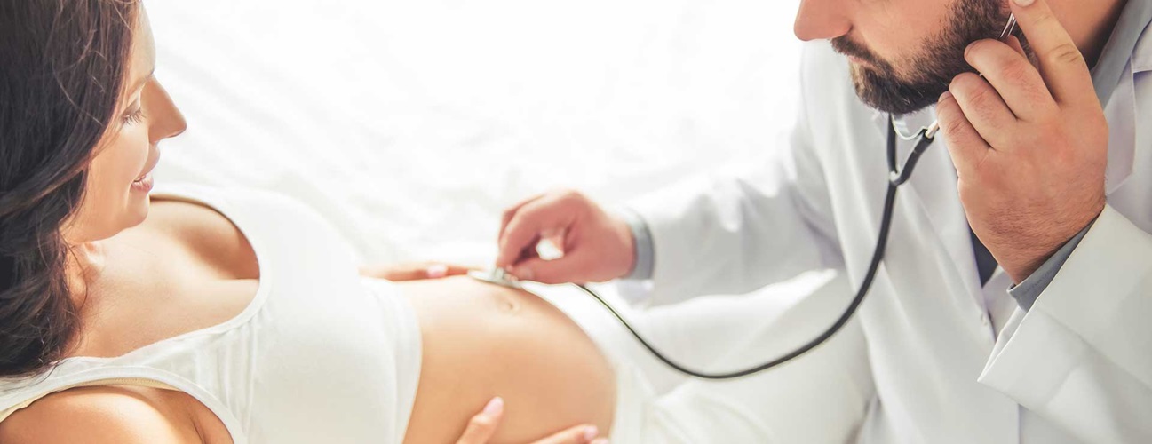 doctor checking baby's heartbeat in a pregnant woman