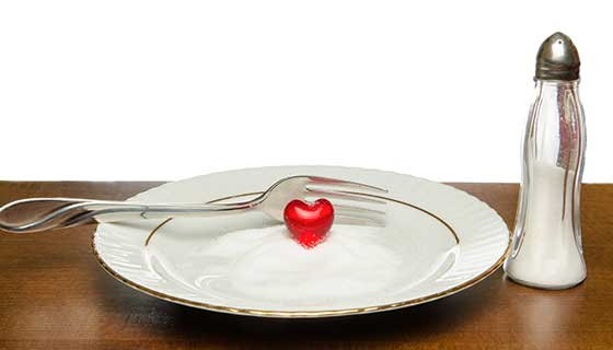 A plate of salt with a red heart figurine on it