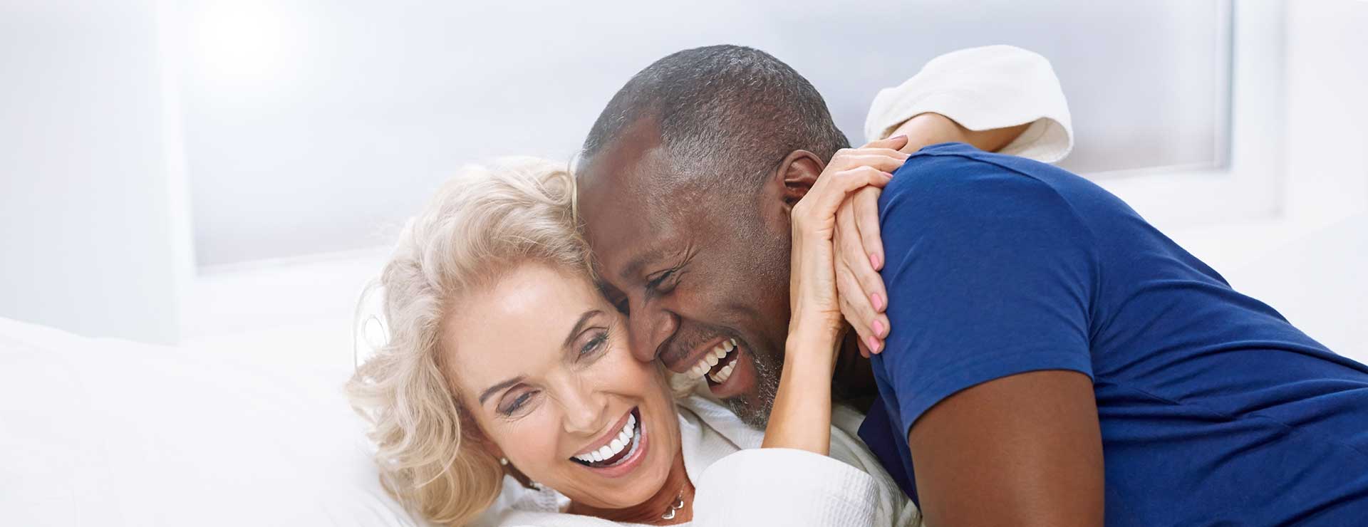 senior couple embracing in bed