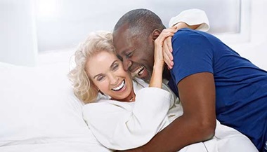 senior couple embracing in bed