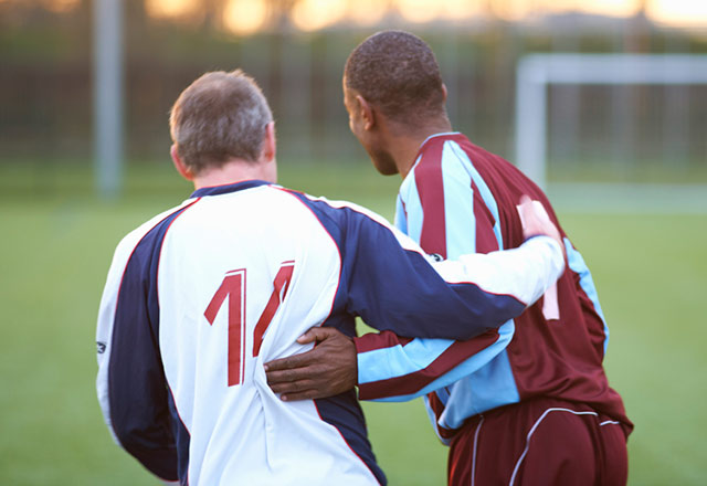 Two soccer players standing in front of the goal