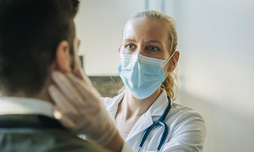 doctor wearing mask examining patient - stay on top of your heart health