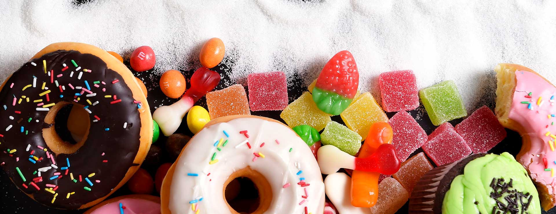donuts, marmalade and other sugary foods laid out on a table