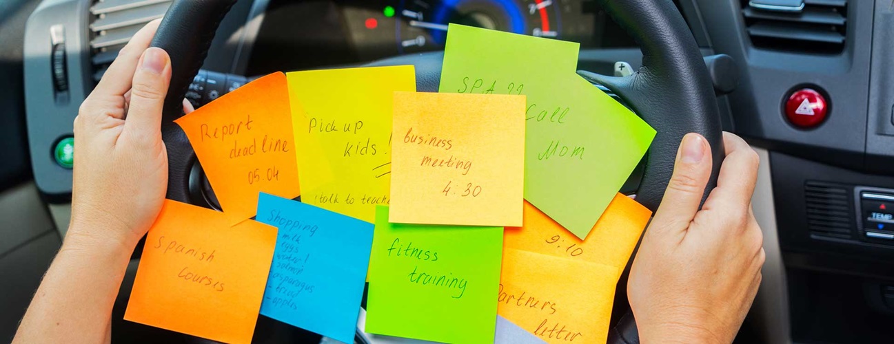 to-do list sticky notes attached to the steering wheel