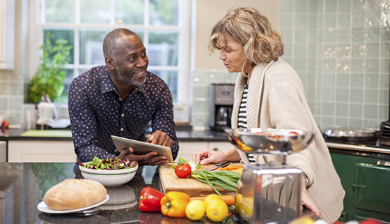 weight loss and diet - couple cooking healthy meal in kitchen