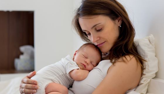 Mother and sleeping newborn