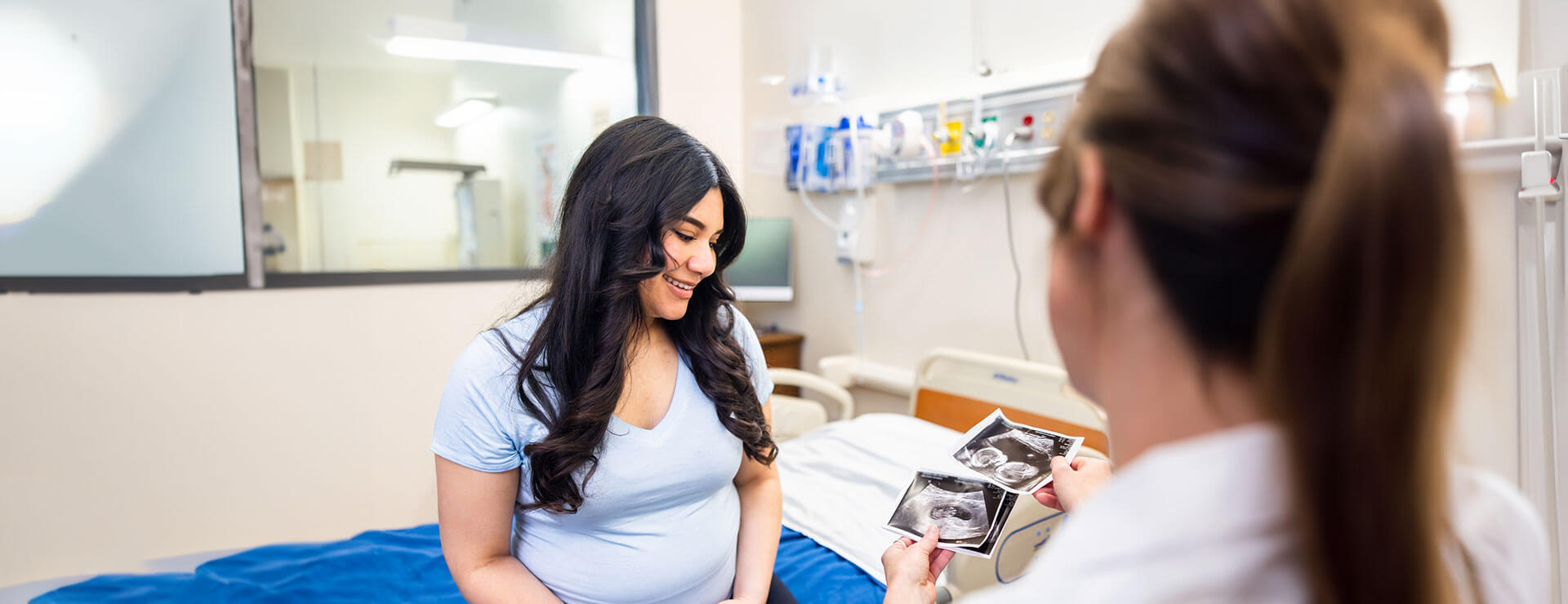 woman looks at sonogram