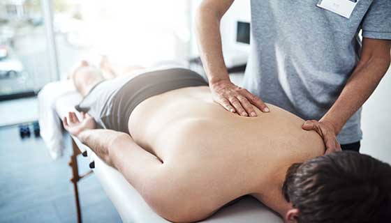 A person receives chiropractic care.