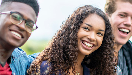 Smiling teens gathered together