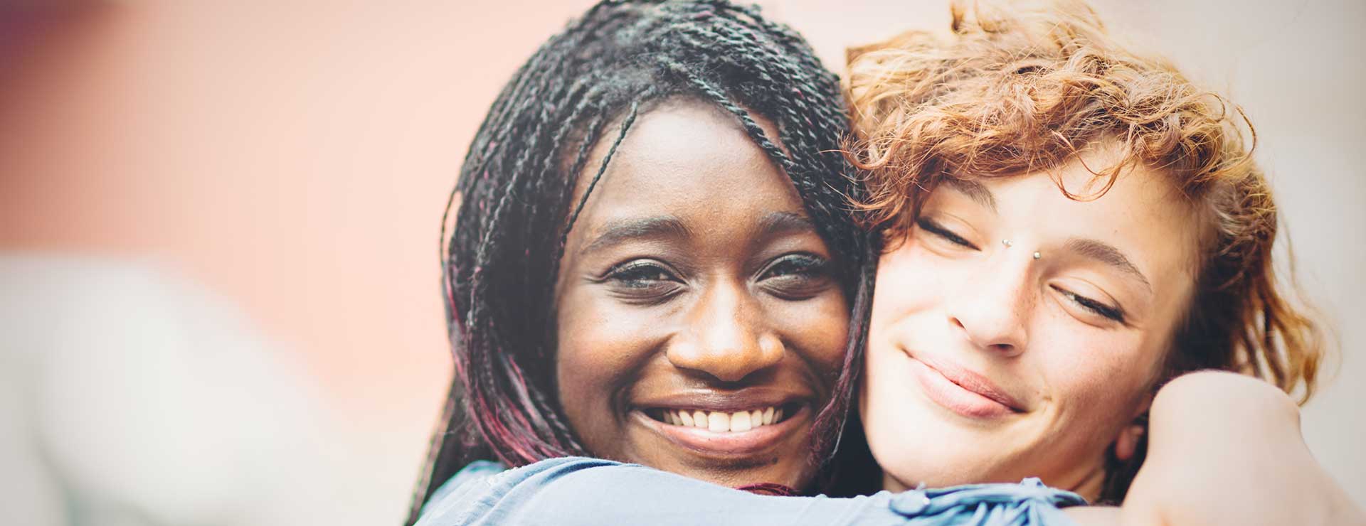 Two people hug.