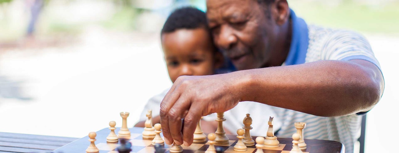man playing chess with grandchild