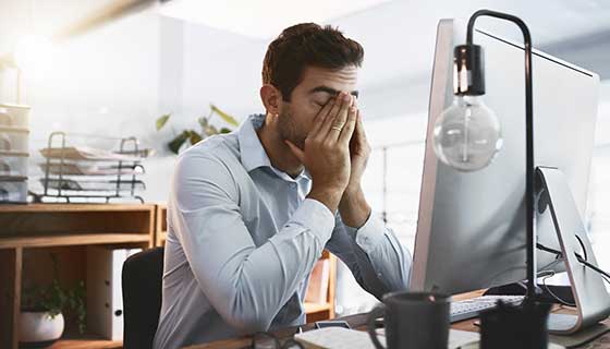 Tired man sitting at his desk