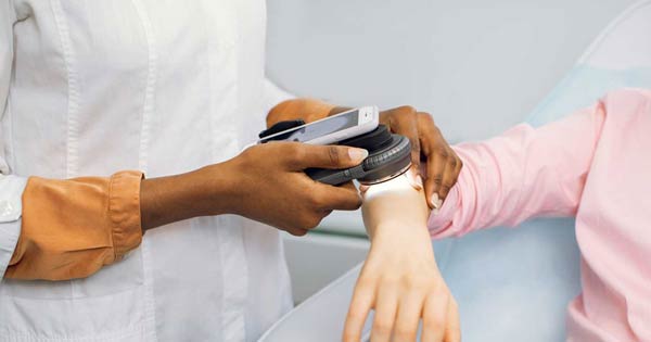 Dermatologist checking patient's skin for skin cancer
