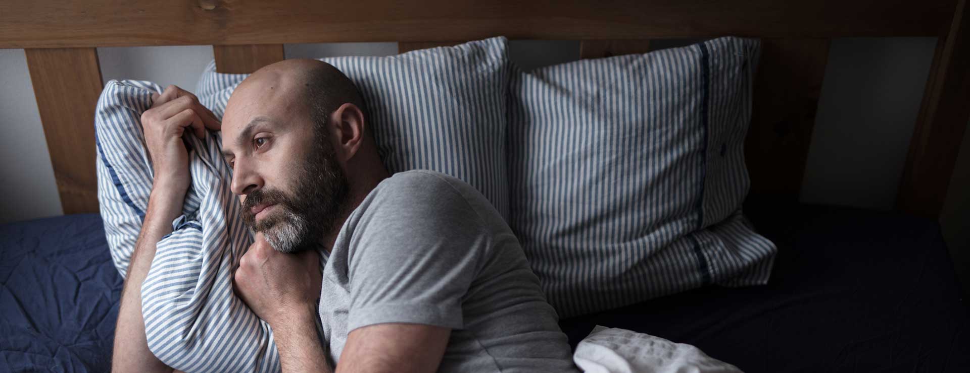 A man lies in bed awake