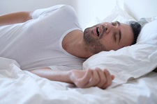 Man with sleep apnea snoring