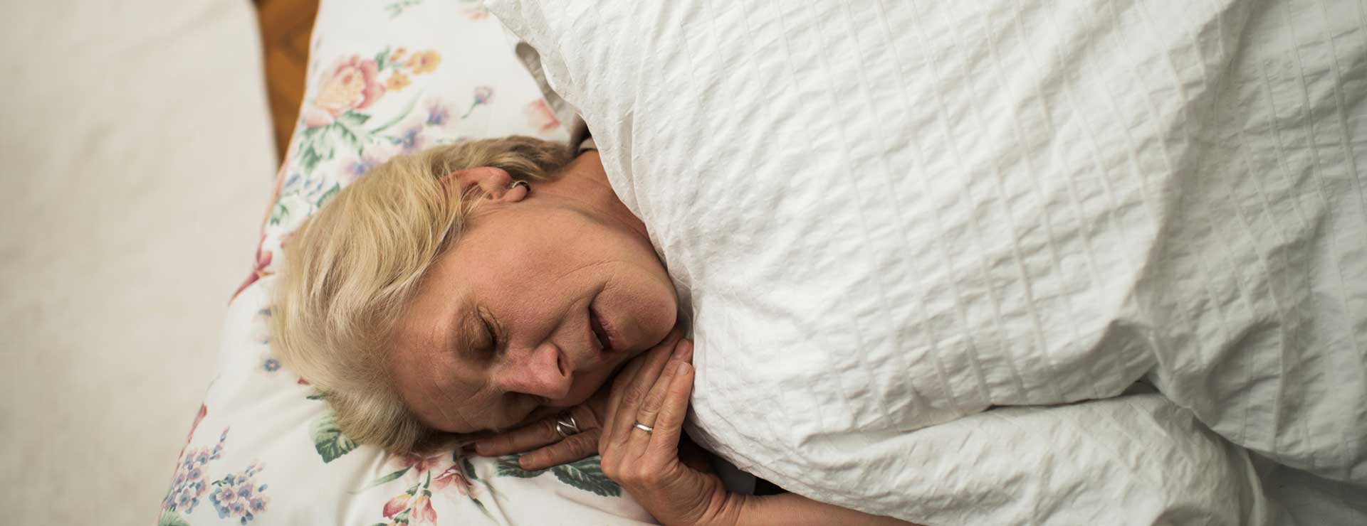 A senior woman sleeping with mouth open