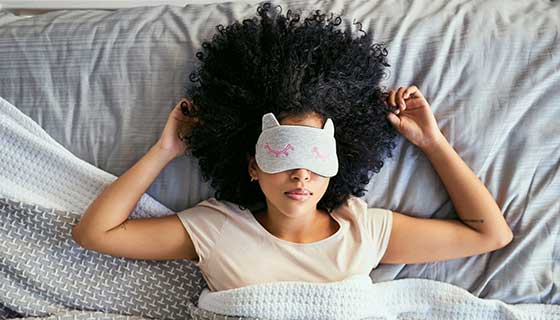 Woman sleeping with a sleep mask on