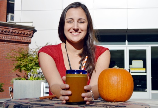 Johns Hopkins research nutritionist Diane Vizthum holding a cup of the healthy pumpkin coffee smoothie.