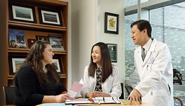 two doctors consulting with a woman