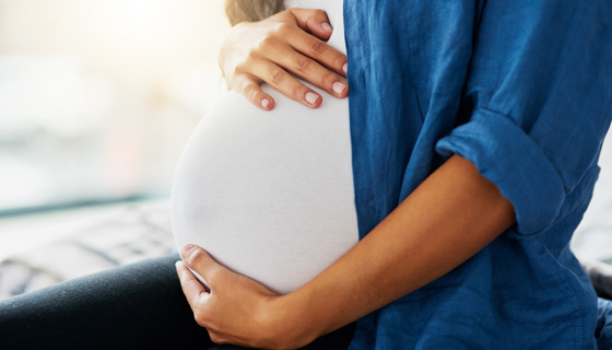 Pregnant woman holder her stomach