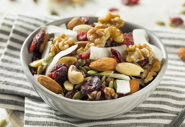 snack mix of nuts and dried fruit in bowl