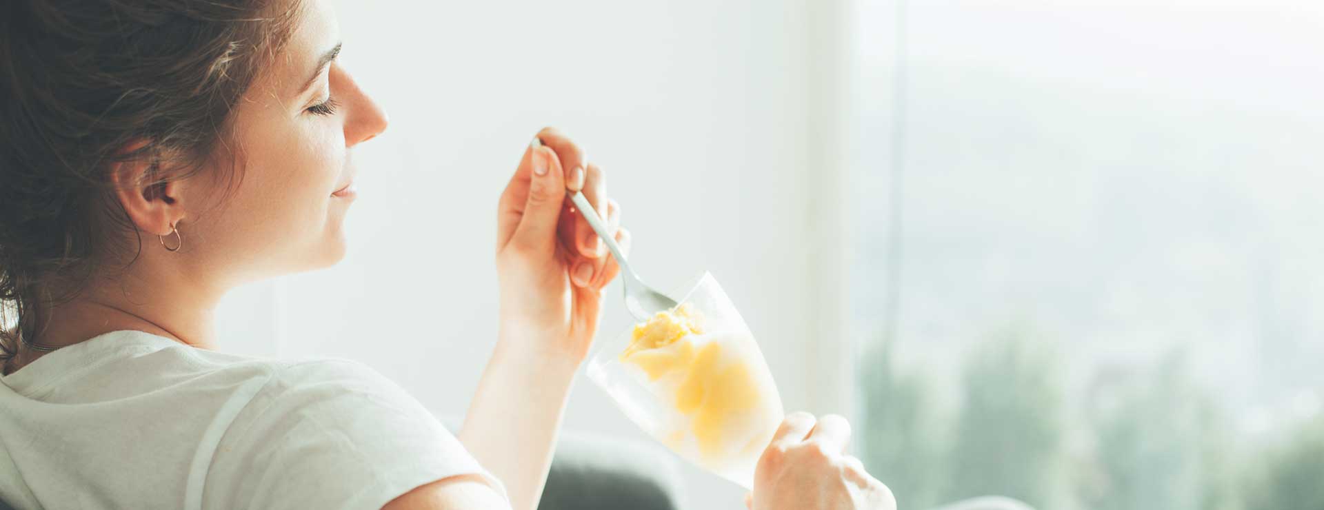 woman enjoying healthy ice cream indoors