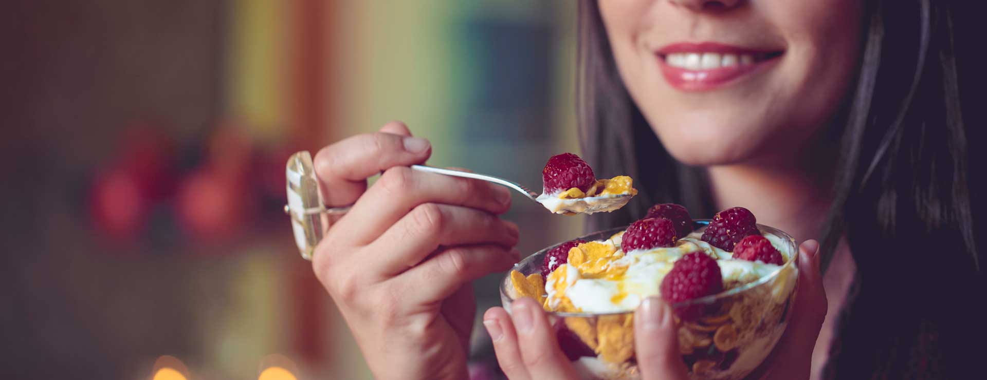A woman holds a bowl of cereal