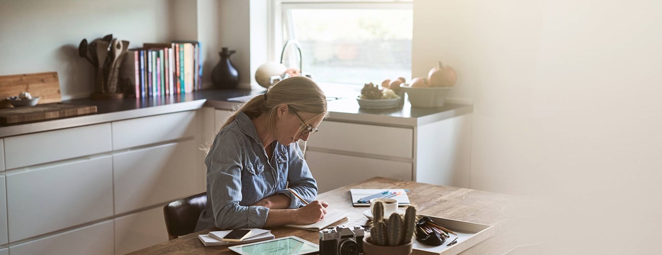 Woman sketching at the kitchen table