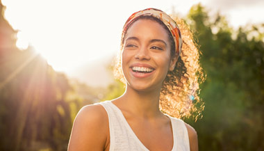 Woman smiling outside in the sun