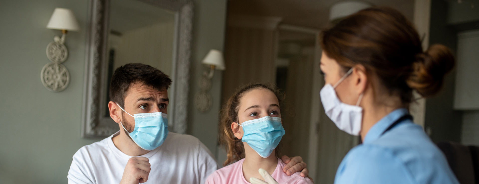 Father and teen talk to pediatric home health nurse