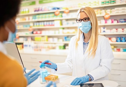 Pharmacist giving medications to a patient