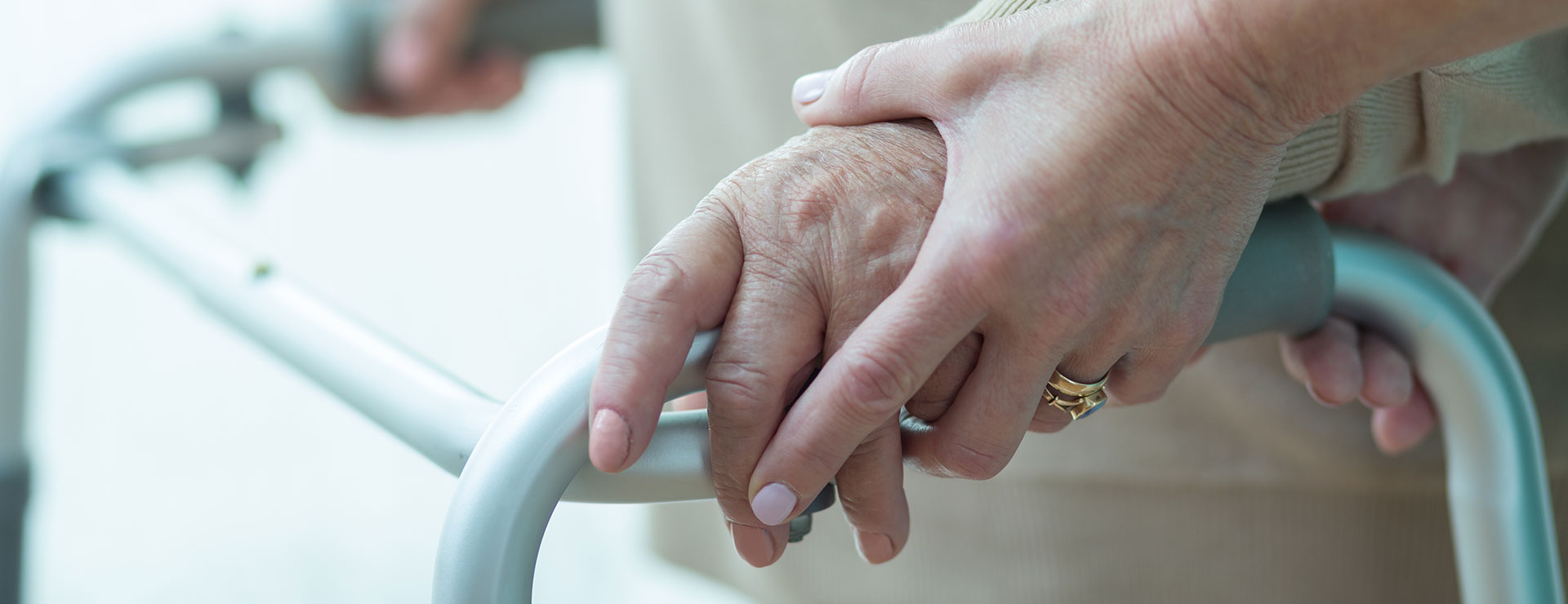 hands using a walker with help
