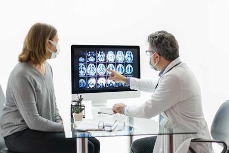 Neurologist discusses brain scan with patient