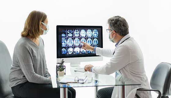 Neurologist discusses brain scan with patient