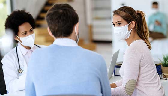 Couple speaking with their doctor