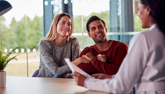 Doctor speaks with young couple