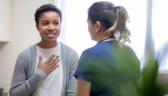 Woman speaking with her physician