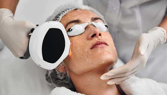Doctor uses a laser on a patient's face