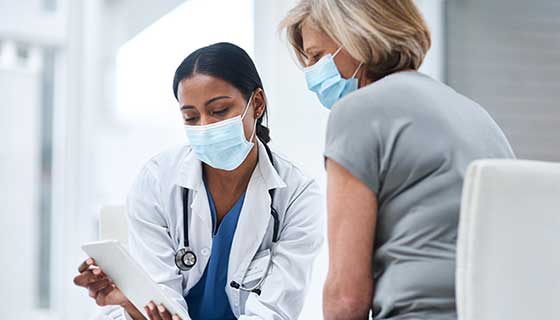 Doctor and patient read an electronic tablet together
