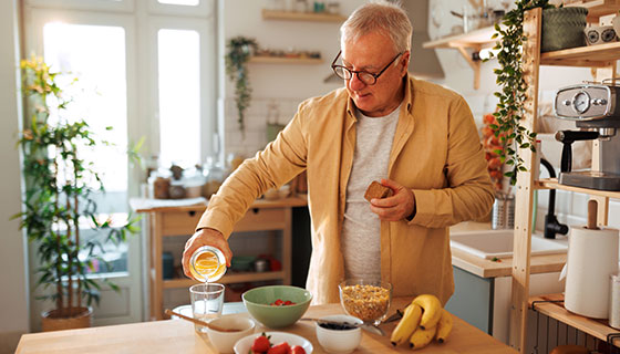 Man prepares healthy breakfast in a bright kitchen