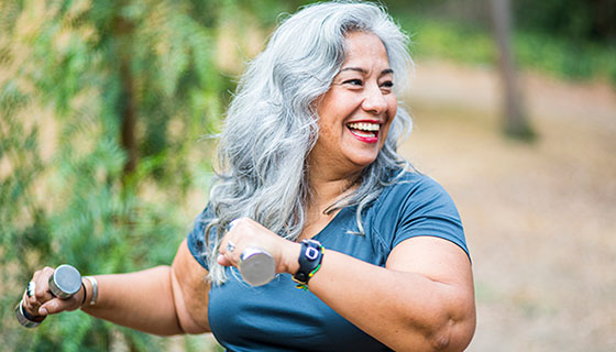 Woman outside with hand weights