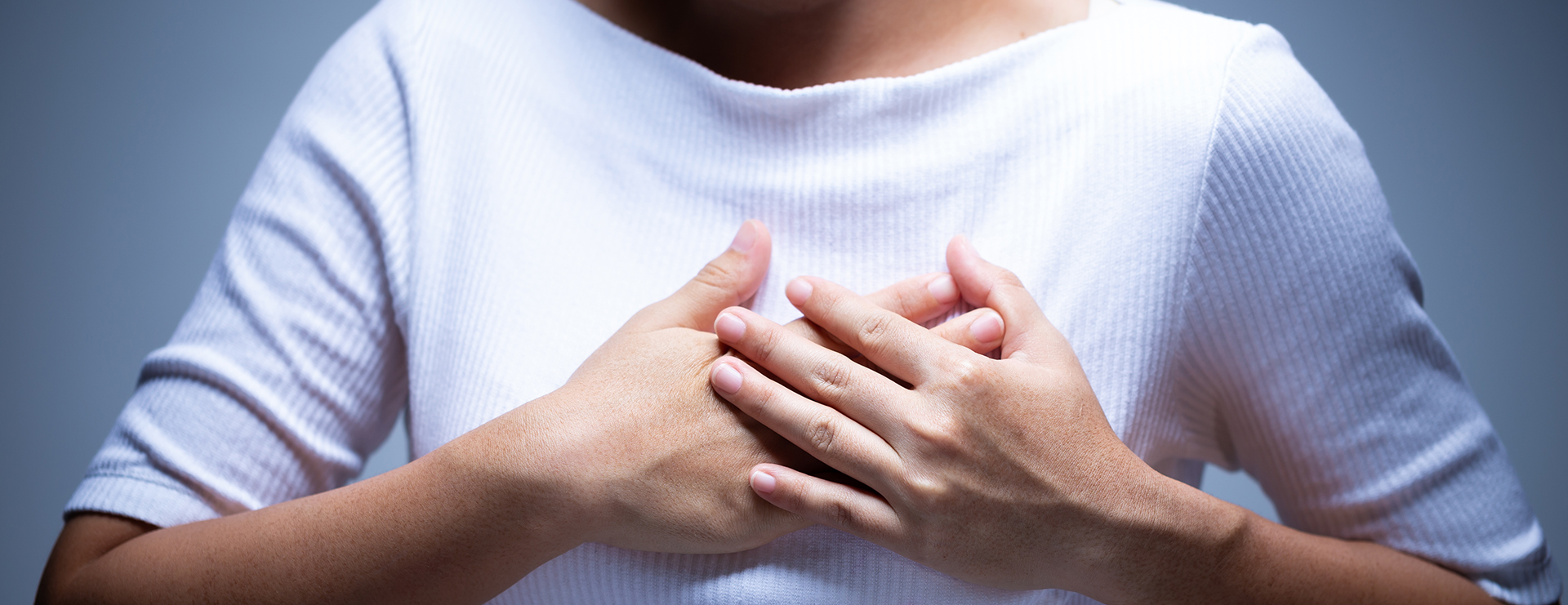 woman with hands on chest