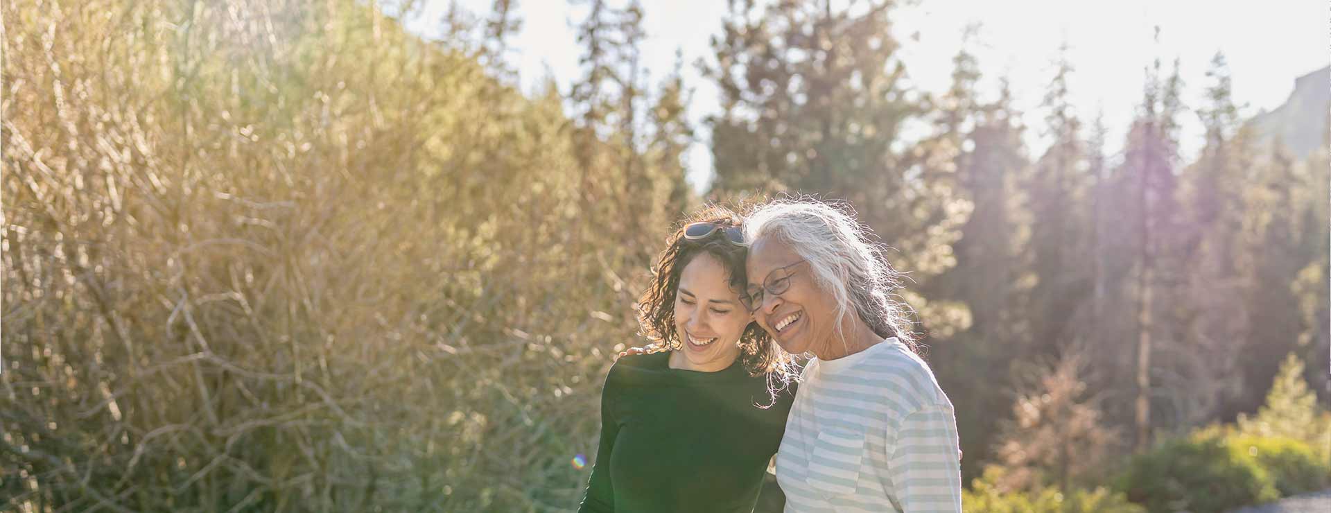 Two women walking in park.