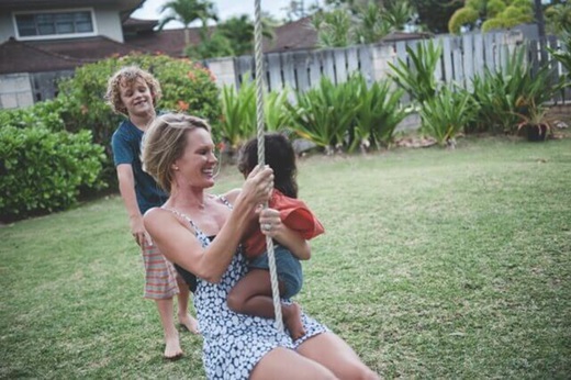 Gina Hammer swings with her child months after operation.