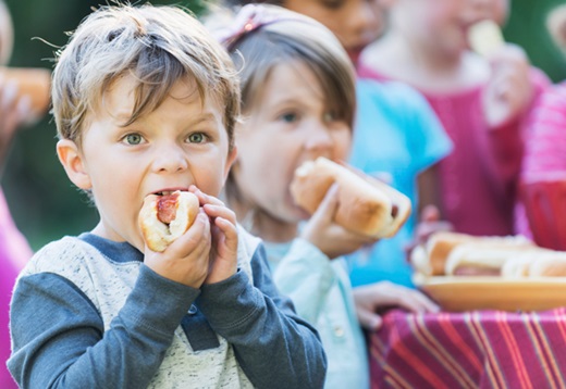 child eating a hot dog