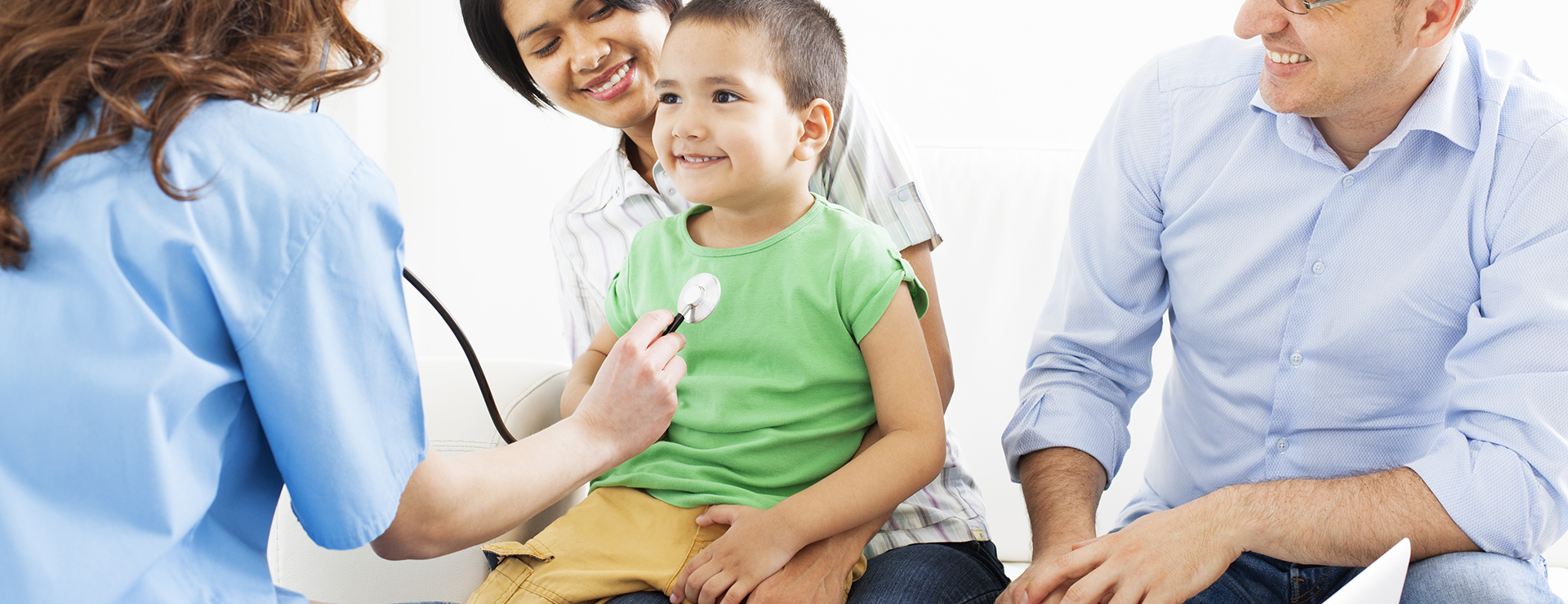 doctor listening to pediatric patient's heart