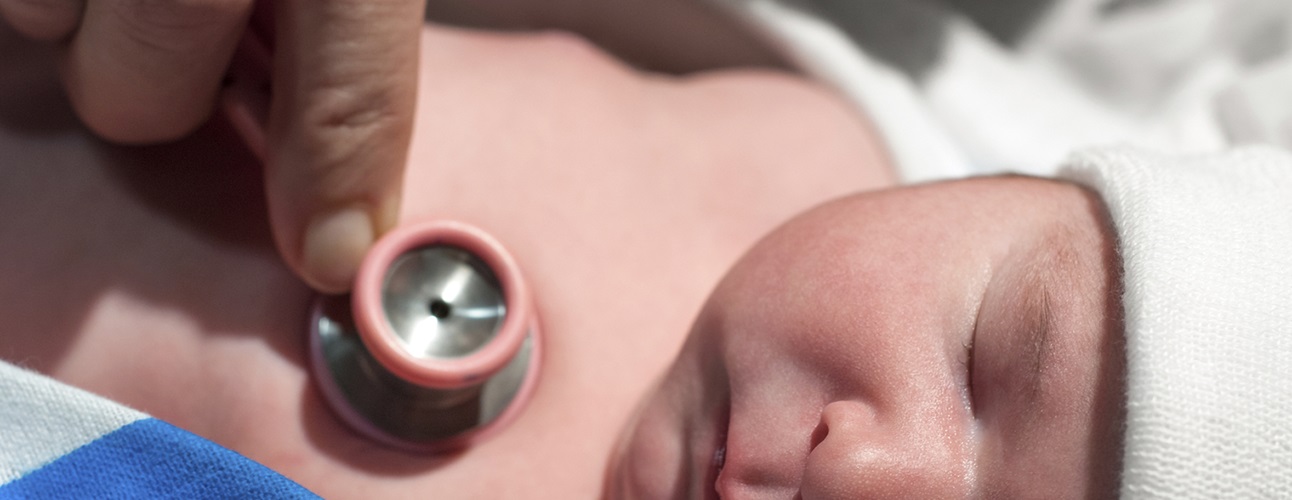 doctor listening to newborn's chest