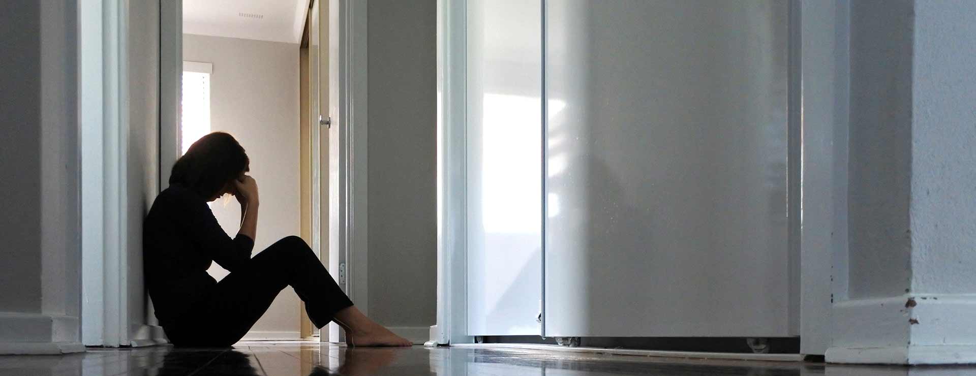 depressed women sitting on floor.