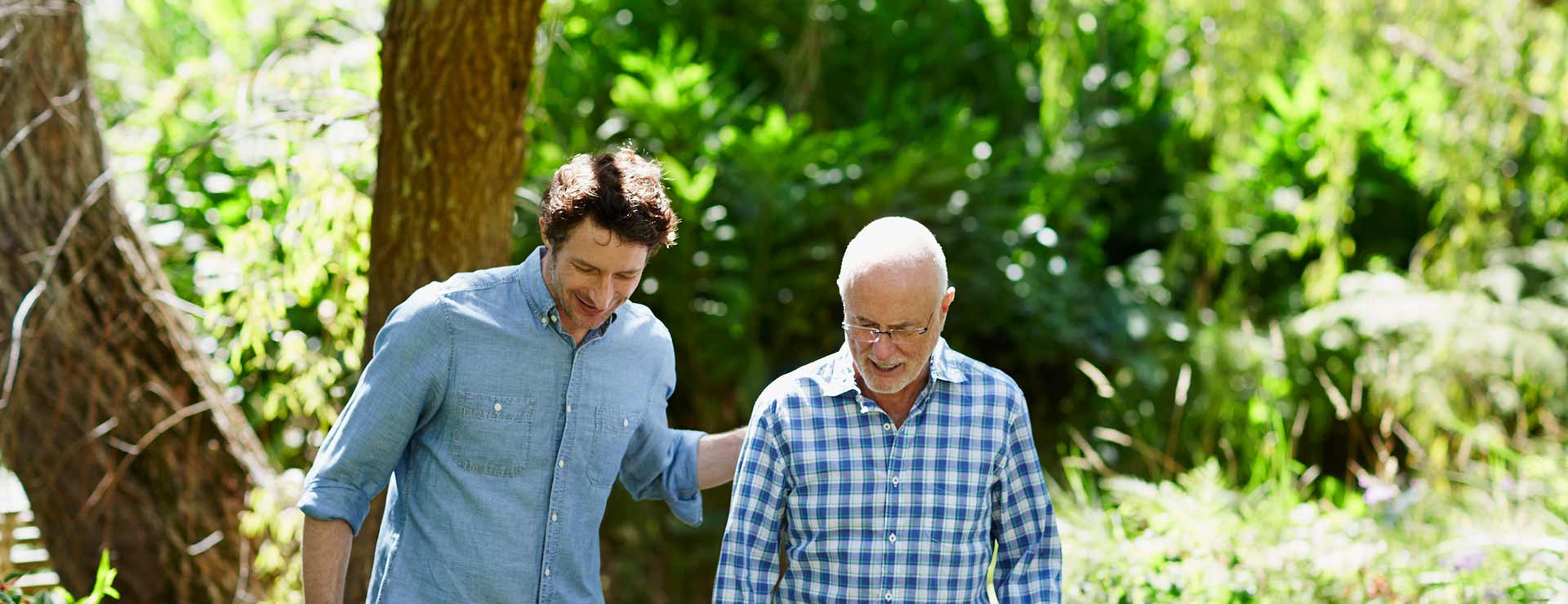 Two men walking together in nature. 